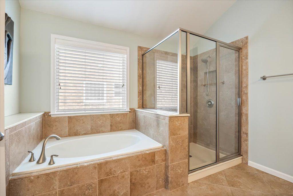 4965 Cheltenham Place Cumming, GA 30041 - Photo 20 of 47 a bathroom with a bathtub and a shower