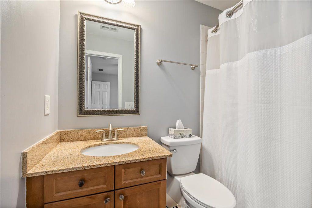 4965 Cheltenham Place Cumming, GA 30041 - Photo 28 of 47 a bathroom with a granite countertop sink toilet and shower