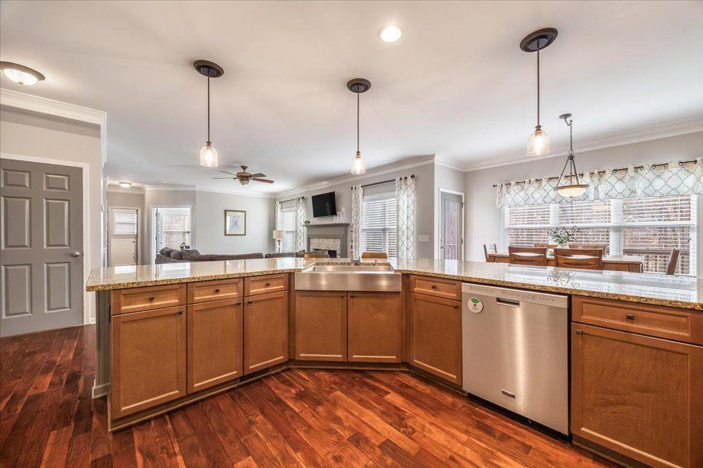 4965 Cheltenham Place Cumming, GA 30041 - Photo 8 of 47 a large kitchen with cabinets chairs and chandelier