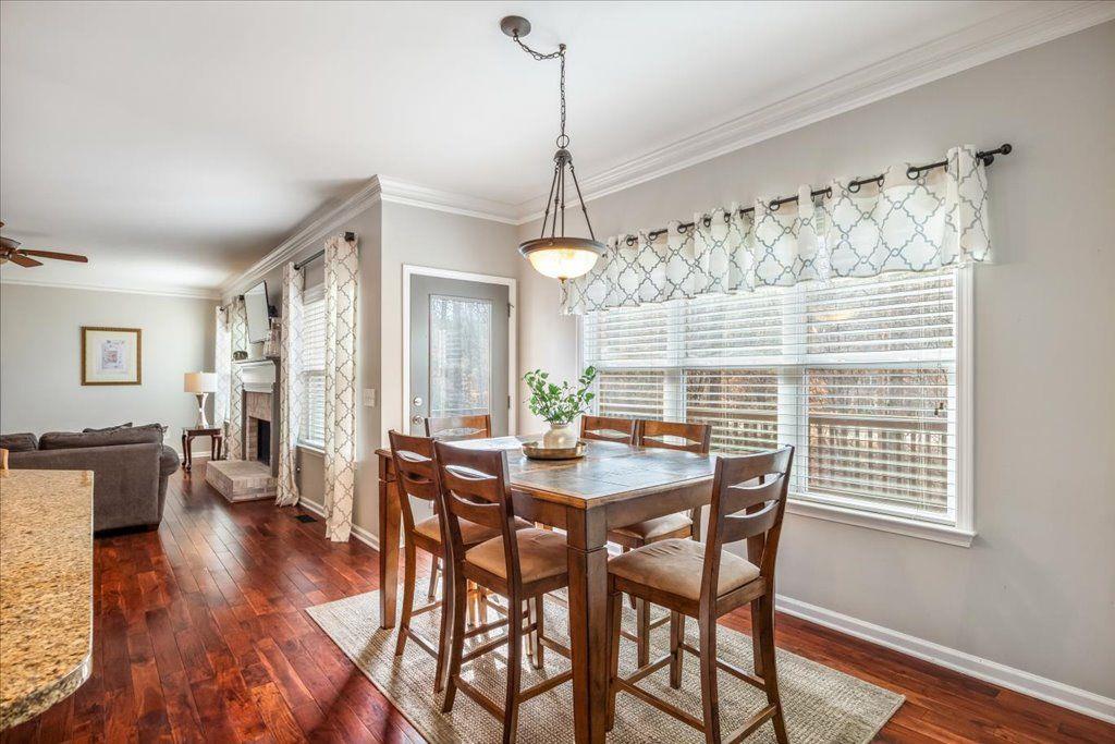 4965 Cheltenham Place Cumming, GA 30041 - Photo 9 of 47 a dining room with furniture window wooden floor