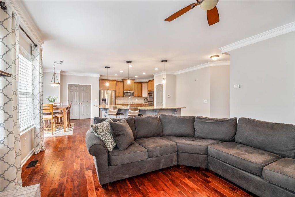4965 Cheltenham Place Cumming, GA 30041 - Photo 10 of 47 a living room with furniture and a large window