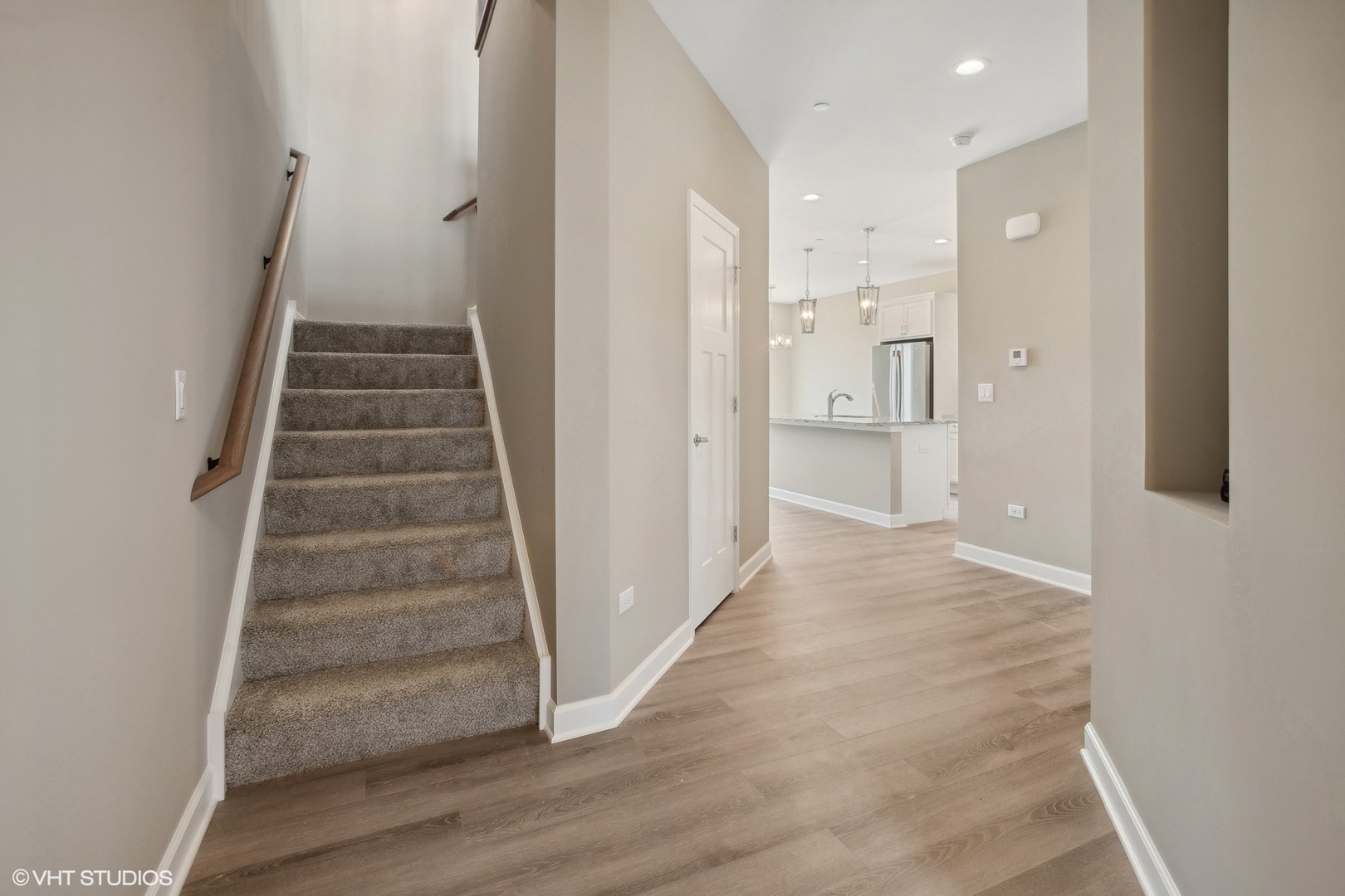 253 Masters Drive Addison, IL 60101 - Photo 2 of 17 a view of a hallway with wooden floor and entryway