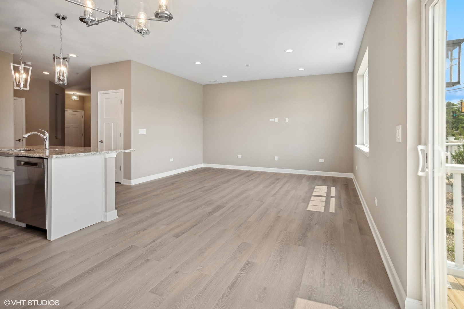 253 Masters Drive Addison, IL 60101 - Photo 4 of 17 an empty room with wooden floor and windows