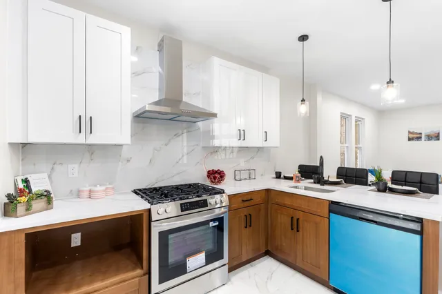 a kitchen with stainless steel appliances granite countertop a sink a stove and a granite counter tops