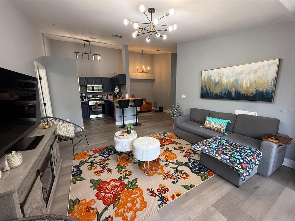 3391 South Kirkman Road, Unit 1236 Orlando, FL 32811 - Photo 12 of 30 a living room with furniture and a flat screen tv
