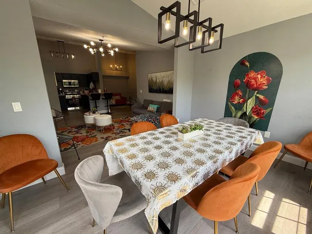 a bedroom with a bed a dresser and balcony view