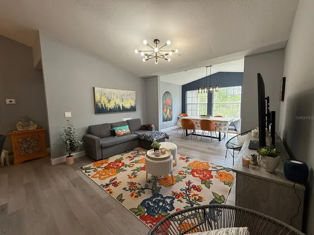 a living room with fireplace furniture and a flat screen tv