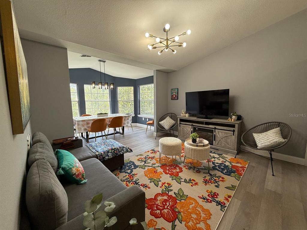 3391 South Kirkman Road, Unit 1236 Orlando, FL 32811 - Photo 16 of 30 a living room with furniture a flat screen tv and a window
