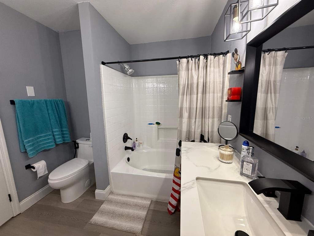 3391 South Kirkman Road, Unit 1236 Orlando, FL 32811 - Photo 20 of 30 a bathroom with a sink toilet and shower