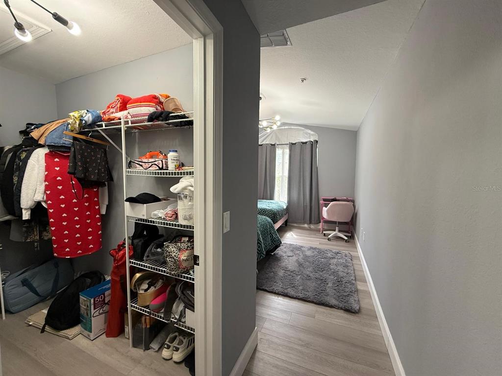 3391 South Kirkman Road, Unit 1236 Orlando, FL 32811 - Photo 22 of 30 a view of a bedroom with clothes shoes and a rug