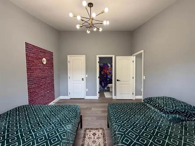 a bedroom with a bed and a chandelier