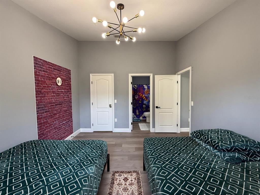 3391 South Kirkman Road, Unit 1236 Orlando, FL 32811 - Photo 27 of 30 a bedroom with a bed and a chandelier