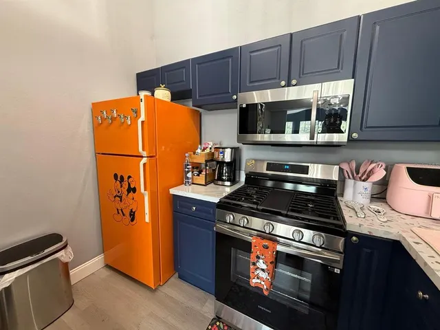 a kitchen with stainless steel appliances granite countertop a stove and a refrigerator