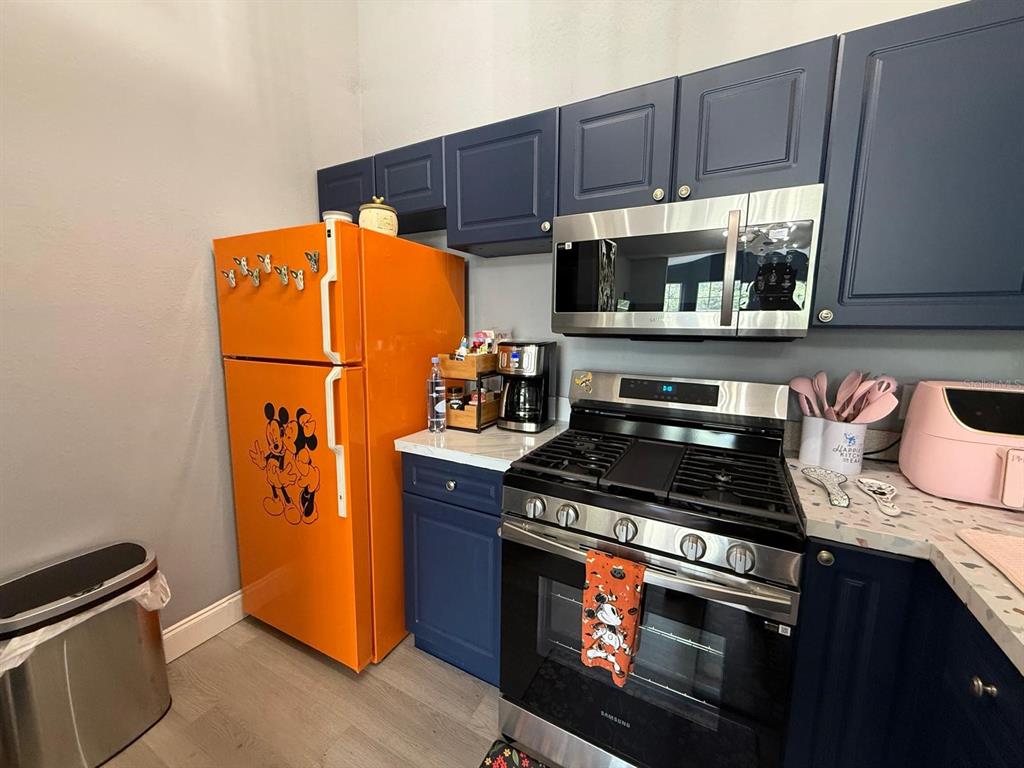 3391 South Kirkman Road, Unit 1236 Orlando, FL 32811 - Photo 6 of 30 a kitchen with stainless steel appliances granite countertop a stove and a refrigerator