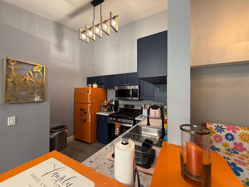 3391 South Kirkman Road, Unit 1236 Orlando, FL 32811 - Photo 7 of 30 a kitchen with stainless steel appliances granite countertop a refrigerator and a stove top oven