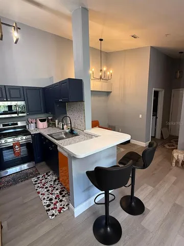 a kitchen with granite countertop a sink stainless steel appliances and cabinets