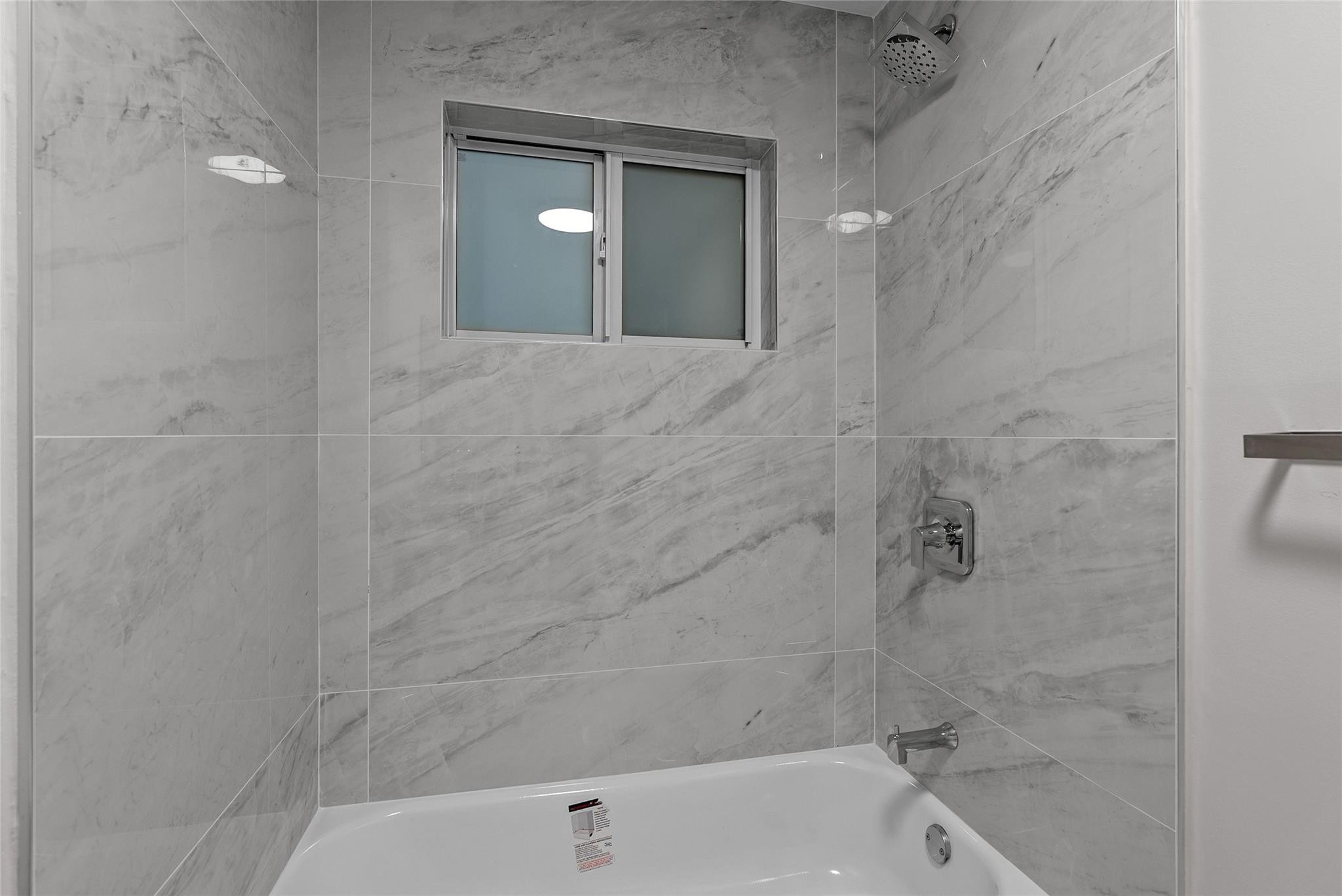 1150 East Sample Road, Unit 202 Pompano Beach, FL 33064 - Photo 15 of 20 a bathroom with a bathtub