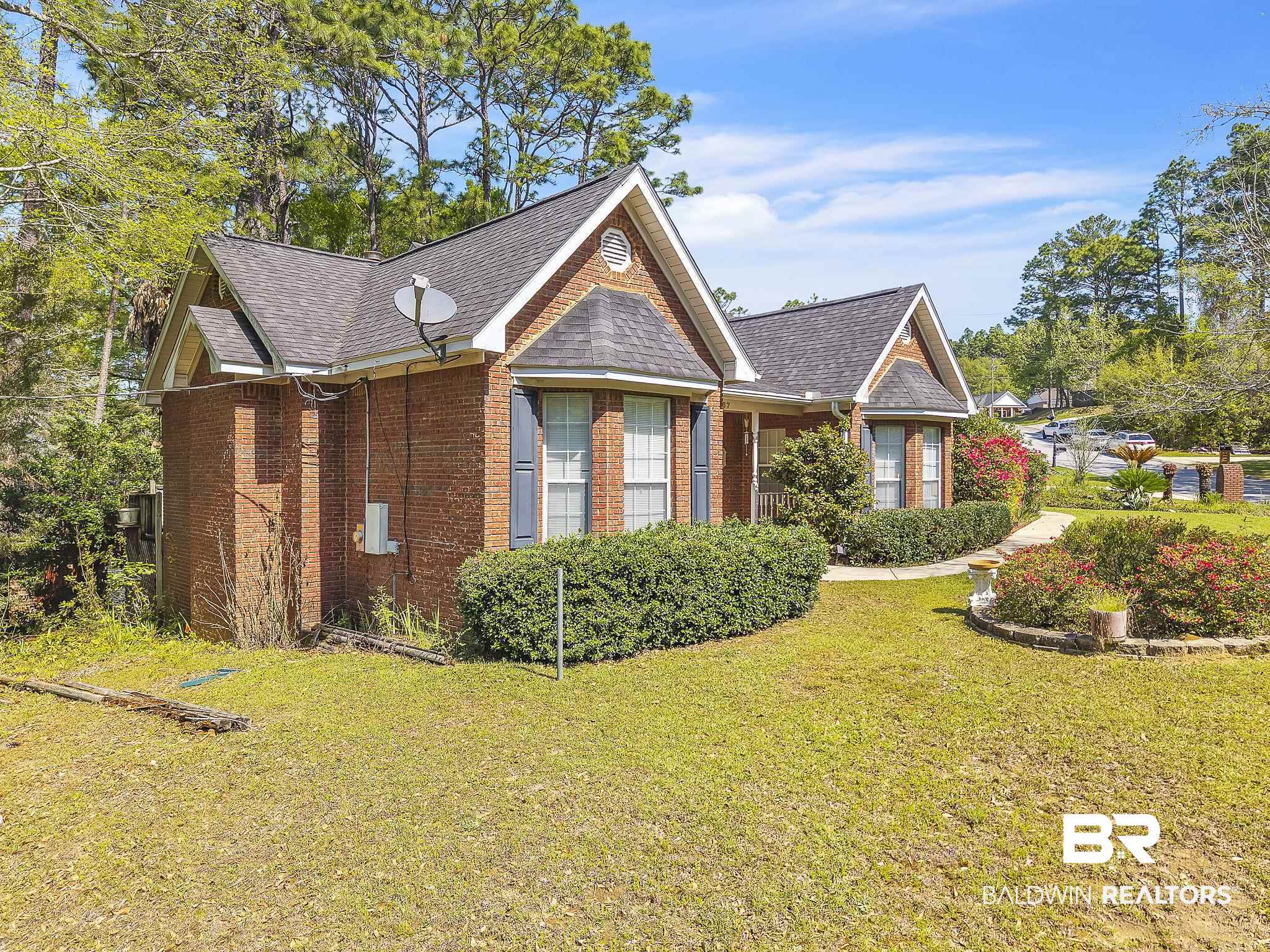 367 Ridgewood Drive Daphne, AL 36526 - Photo 4 of 71 View of front facade featuring brick siding, a front yard, and a shingled roof