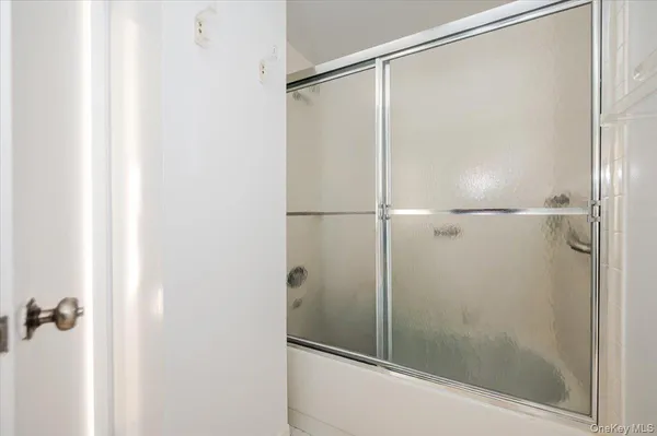 a bathroom with a glass shower door