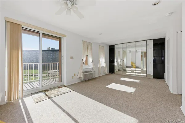 a view of a room with wooden floor and windows