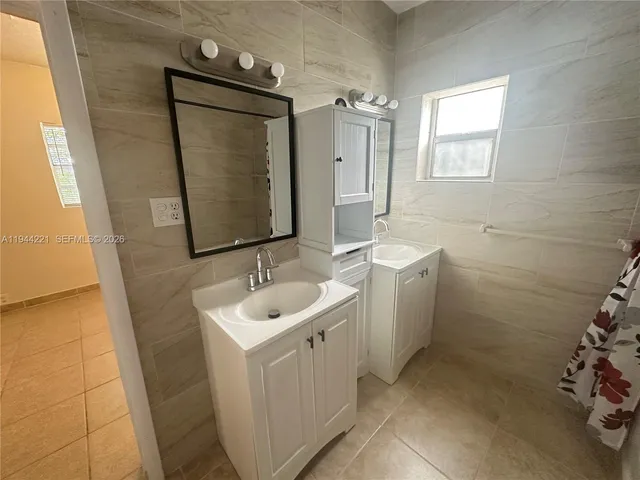 a view of a house with yard and tree s