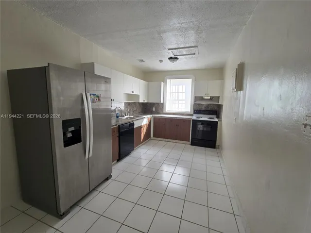 an empty room with a empty space and windows