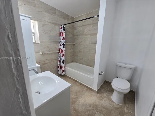 a bathroom with a shower and a toilet