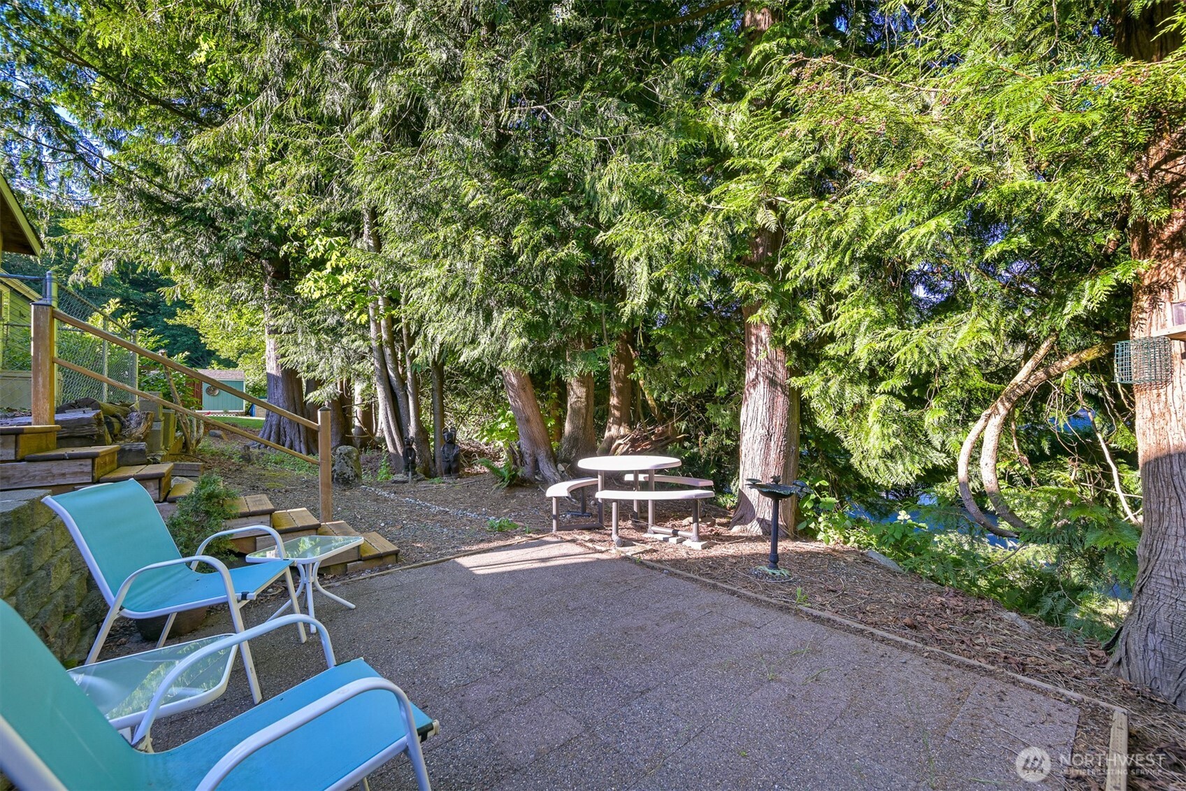 2174 Yew Street Road, Unit 22 Bellingham, WA 98229 - Photo 32 of 36 a view of backyard with a table and chairs and a large tree