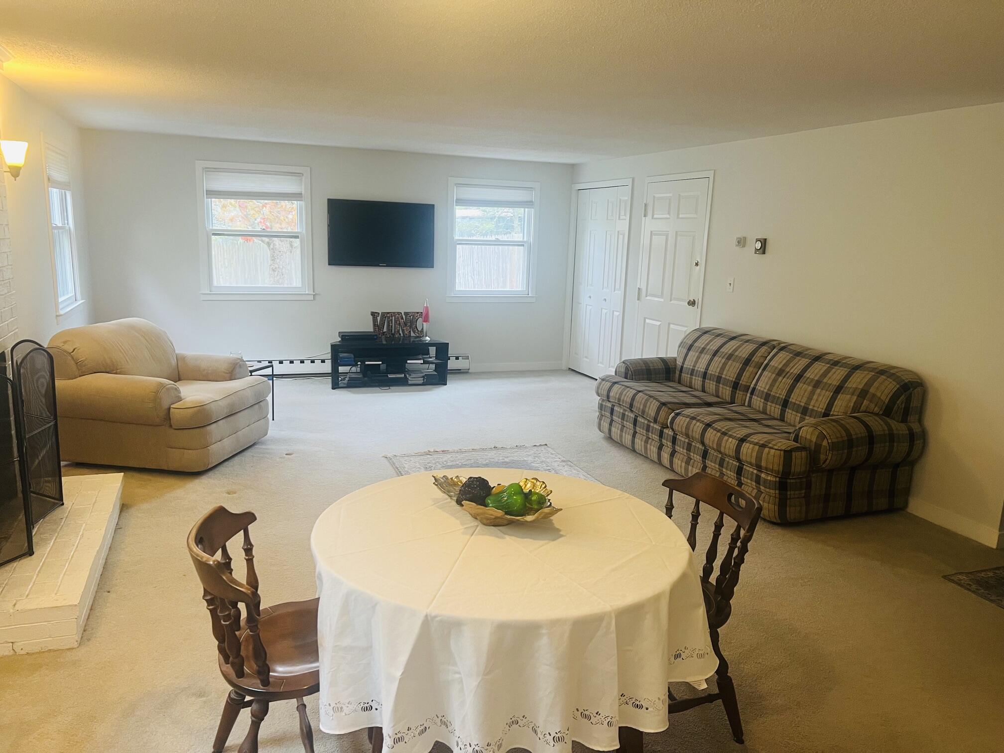 1431 Iyannough Road, Unit 1 Centerville, MA 02632 - Photo 10 of 28 a living room with furniture and a flat screen tv
