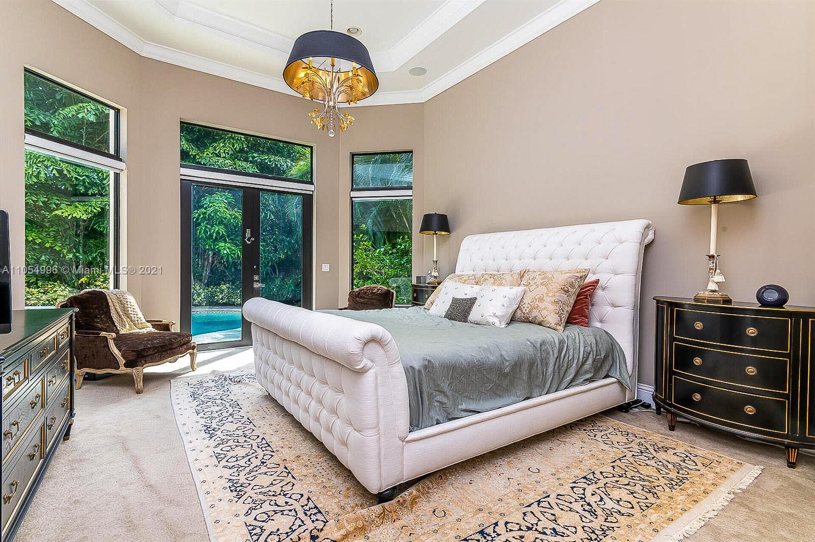 17766 Cadena Drive Boca Raton, FL 33496 - Photo 14 of 28 a bedroom with a bed and a chandelier