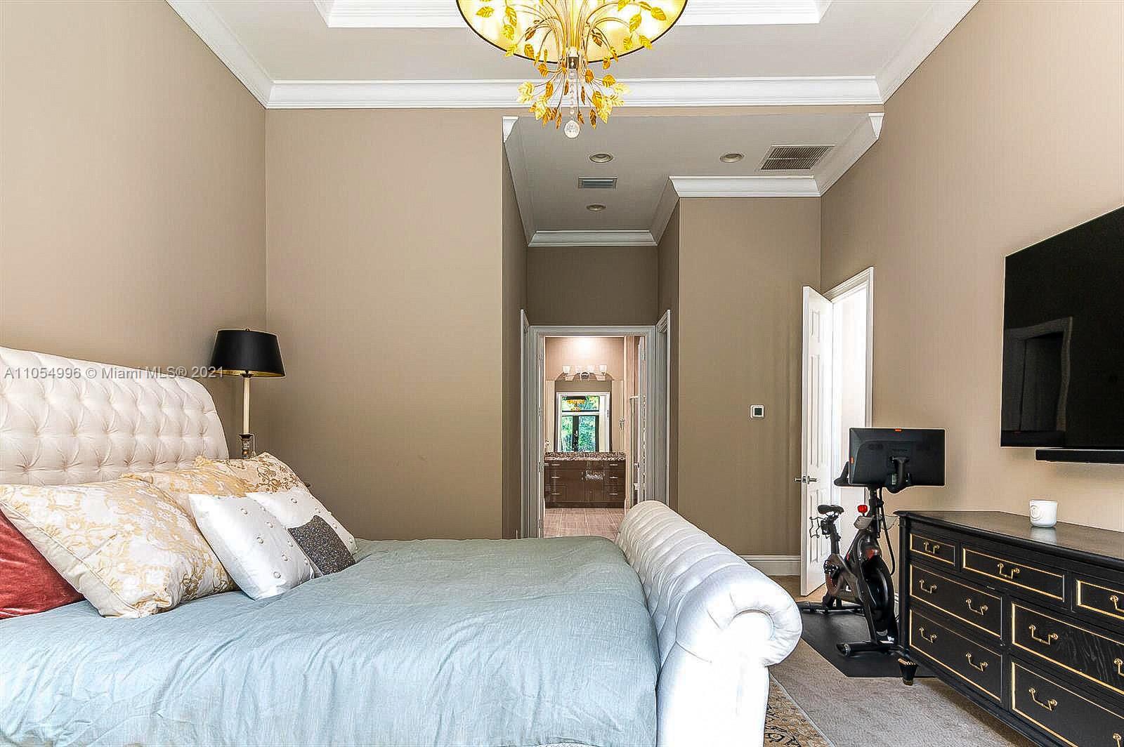 17766 Cadena Drive Boca Raton, FL 33496 - Photo 15 of 28 a bedroom with a bed and a chandelier