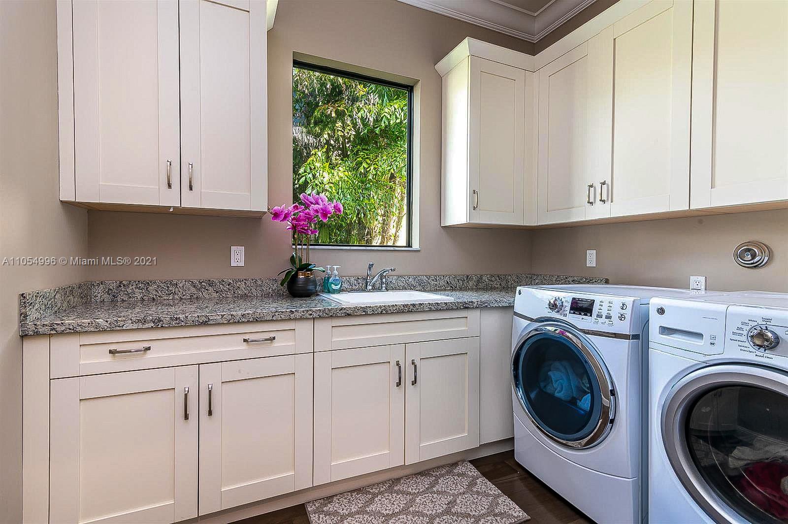 17766 Cadena Drive Boca Raton, FL 33496 - Photo 21 of 28 a kitchen with granite countertop white cabinets and a sink