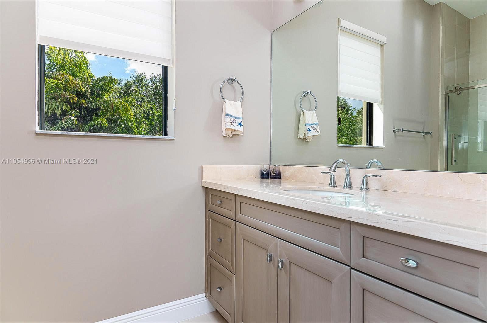 17766 Cadena Drive Boca Raton, FL 33496 - Photo 23 of 28 a bathroom with a granite countertop sink and a mirror