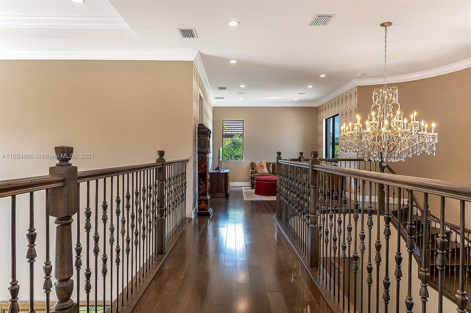 17766 Cadena Drive Boca Raton, FL 33496 - Photo 24 of 28 a view of a hallway with furniture and a chandelier