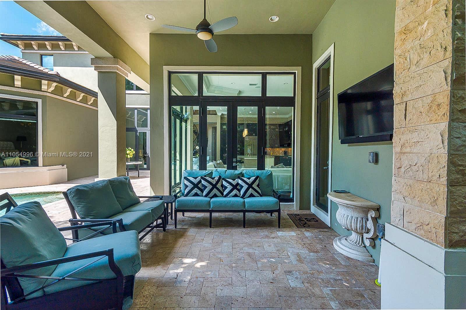 17766 Cadena Drive Boca Raton, FL 33496 - Photo 25 of 28 a living room with furniture and a flat screen tv