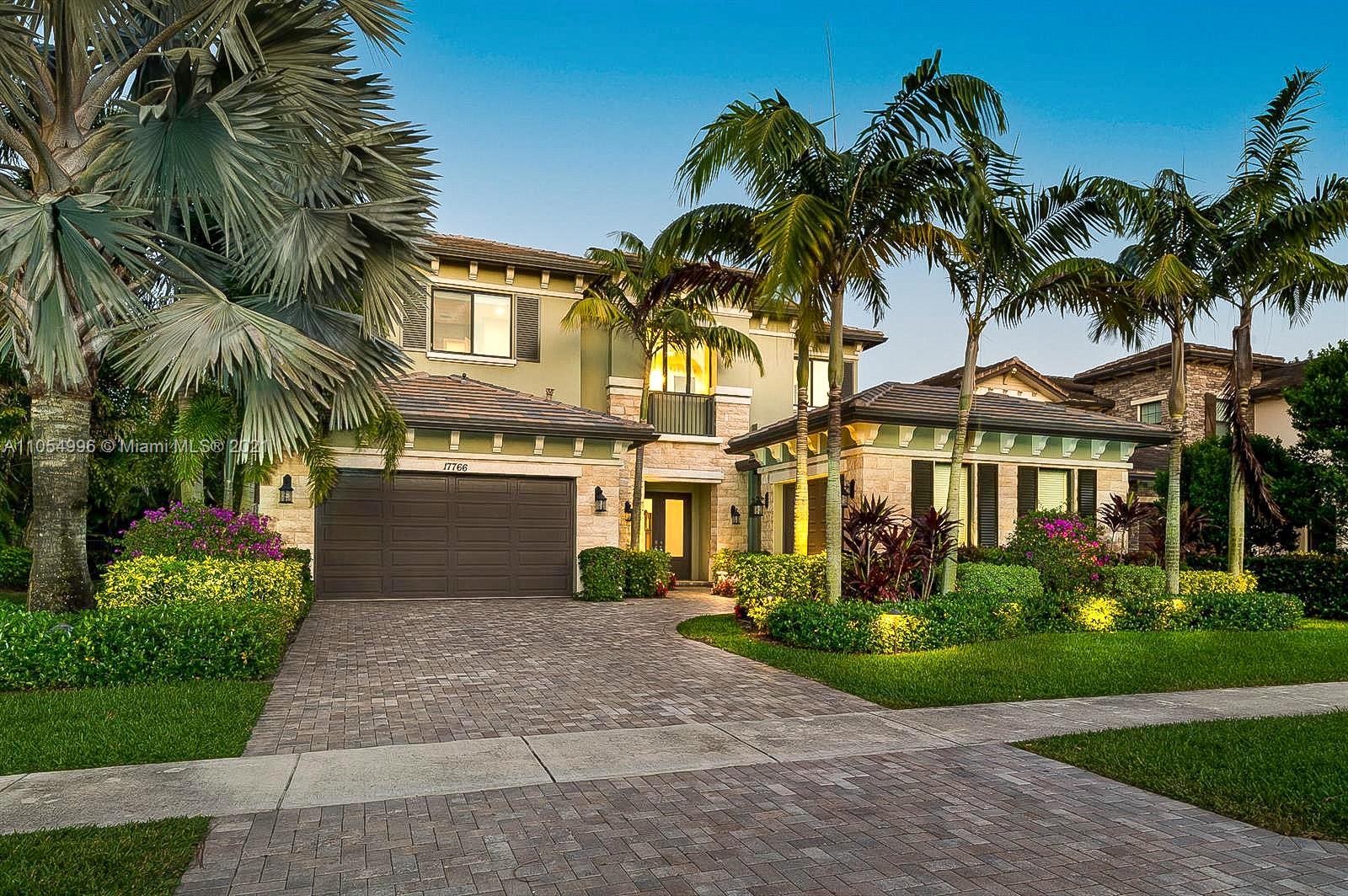 17766 Cadena Drive Boca Raton, FL 33496 - Photo 3 of 28 a front view of a house with a yard and palm trees