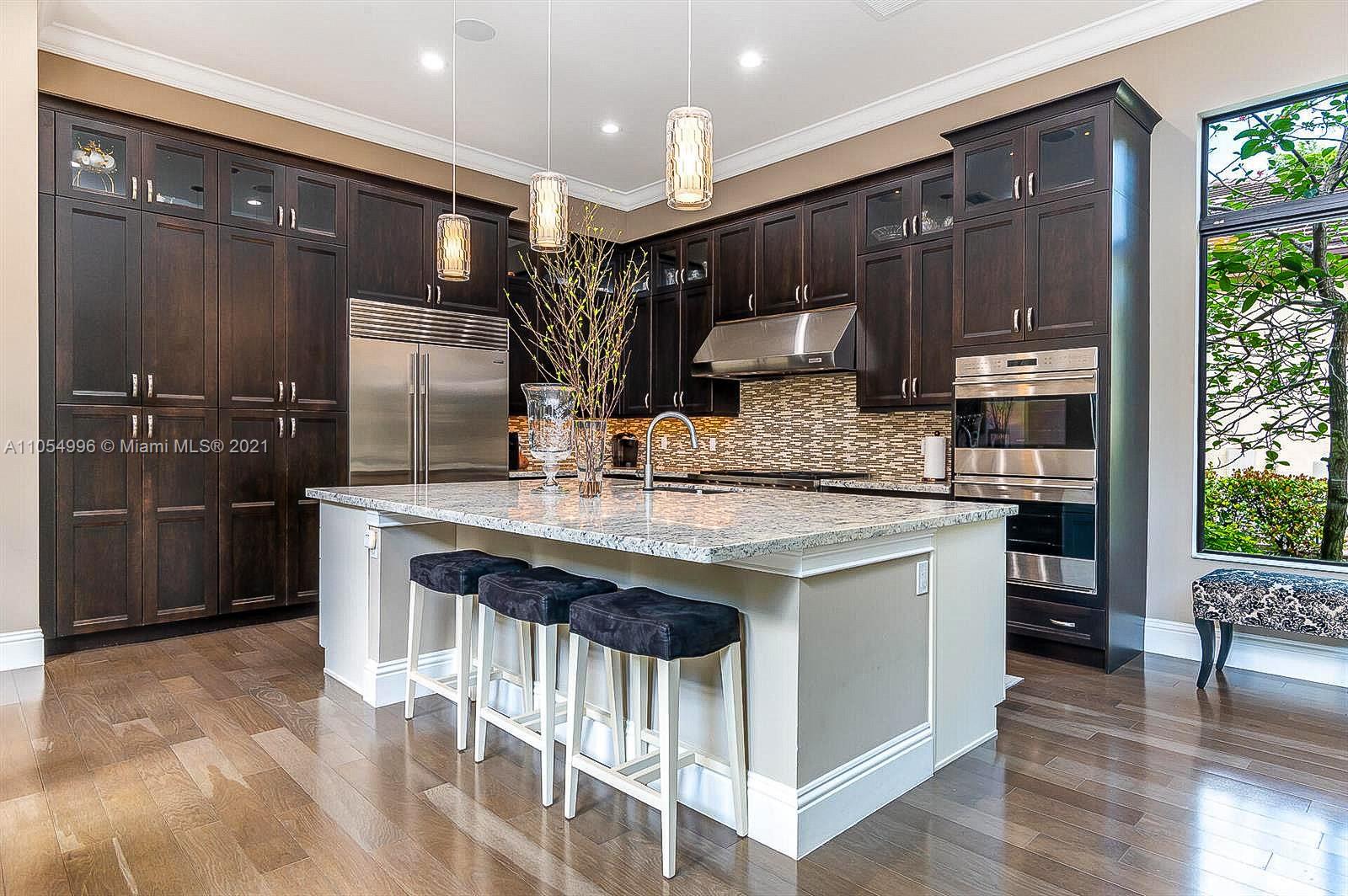 17766 Cadena Drive Boca Raton, FL 33496 - Photo 6 of 28 a kitchen with stainless steel appliances granite countertop a sink stove and refrigerator