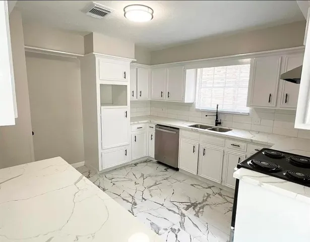 a view of a livingroom with a ceiling fan and window