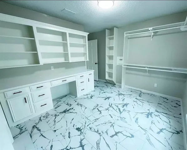 a bathroom with double vanity sink a mirror and a bathtub