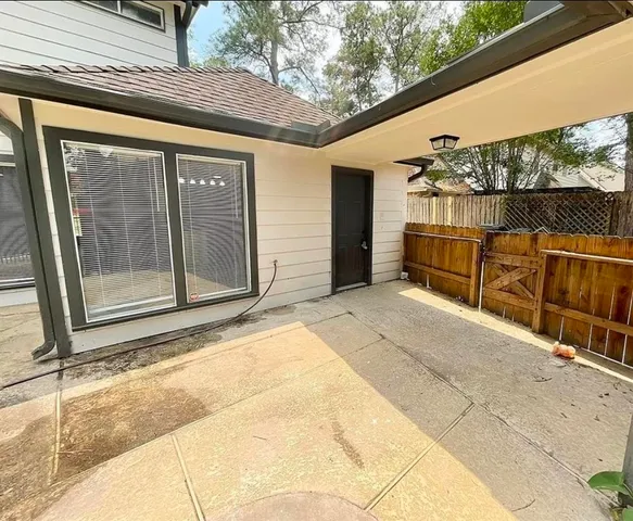 a backyard of a house with basket ball court