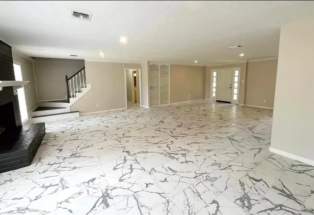 a view of a livingroom with wooden floor and a flat screen tv
