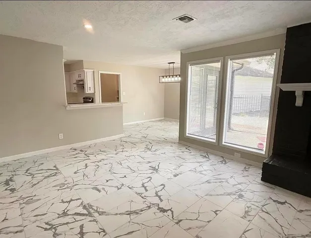 a kitchen with granite countertop a sink stove and cabinets