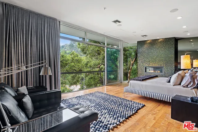 a view of a bedroom with a bed and glass door