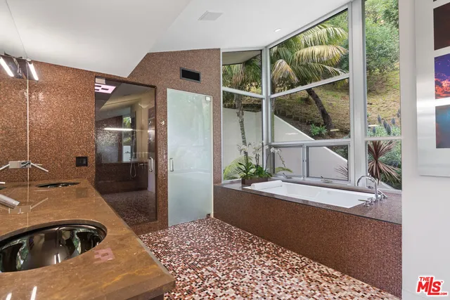 a bathroom with mirror and window