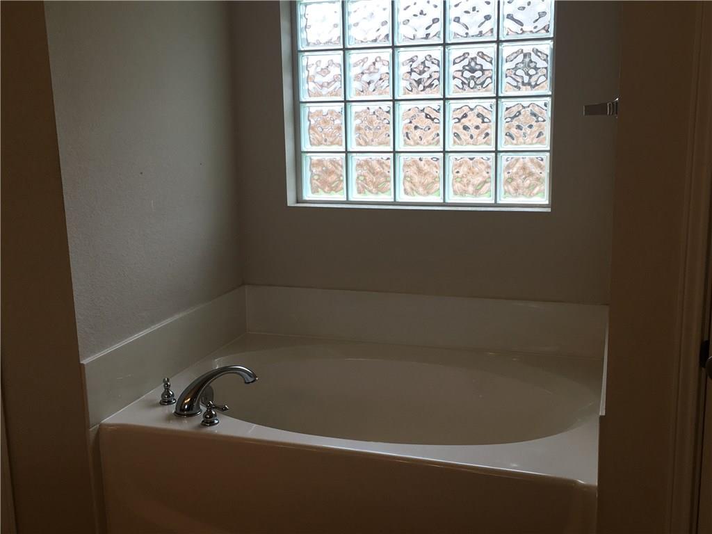 2218 Old Ironsides Road Abilene, TX 79601 - Photo 20 of 26 a bath tub sitting next to a window