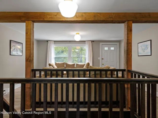 a view of a room with wooden floor and windows
