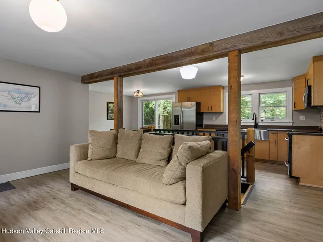 a bathroom with a granite countertop bathtub sink vanity mirror and toilet
