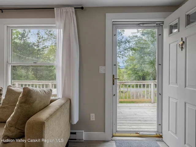 a view of a dining room with furniture a chandelier and wooden floor