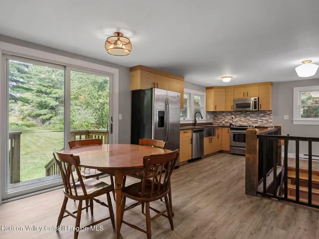 a kitchen with granite countertop a stove a sink and a refrigerator