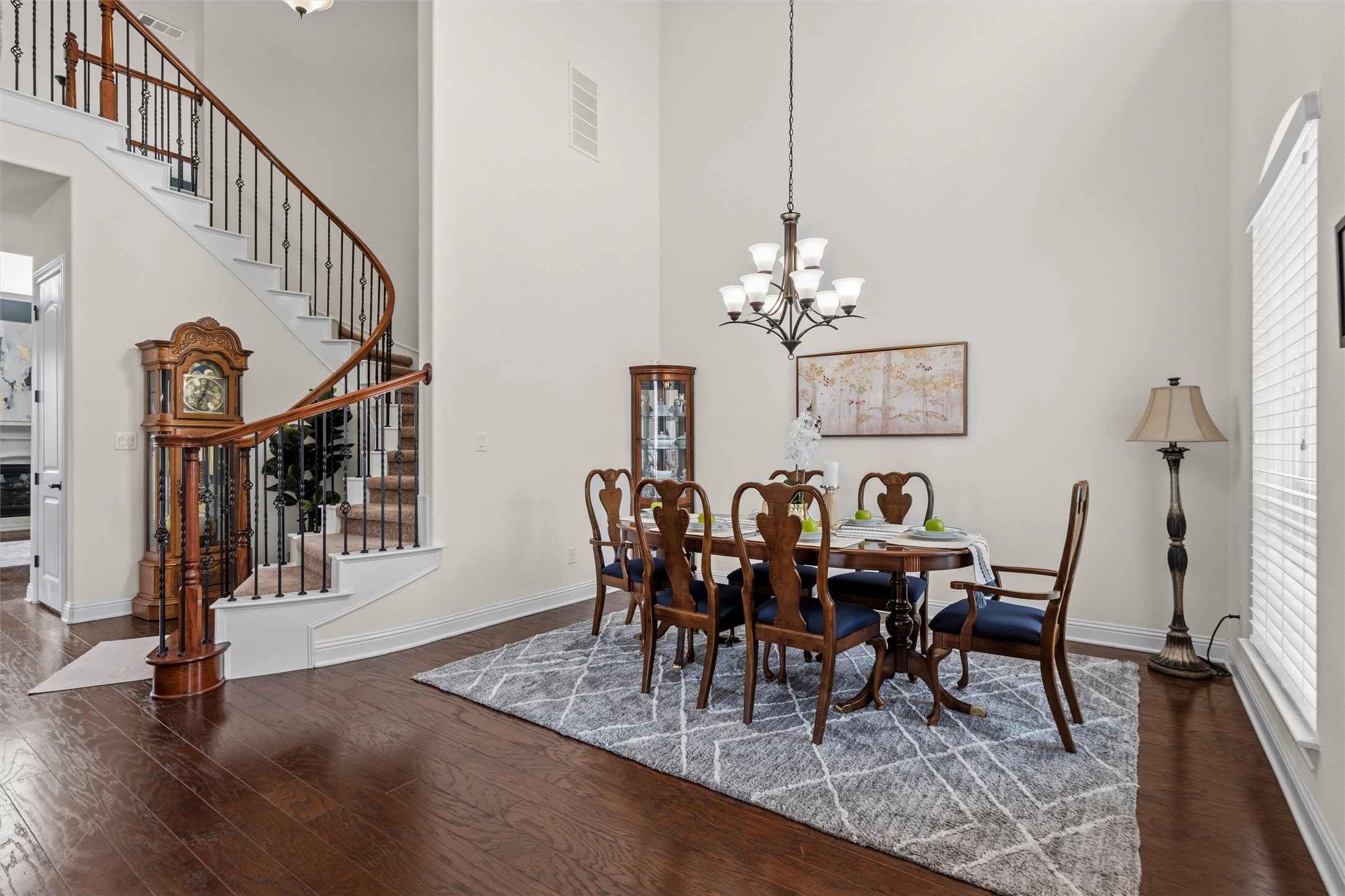 1733 Siena Sunset Road Leander, TX 78641 - Photo 13 of 40 Hardwood flooring throughout a dining area featuring a window with white blinds and a chandelier